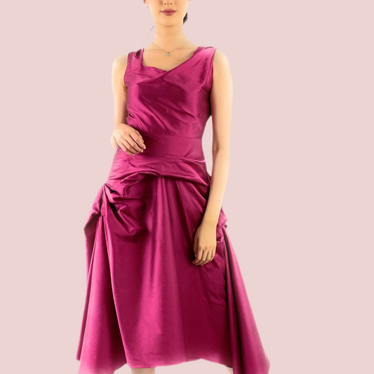 Woman wearing a magenta dress on a pink background