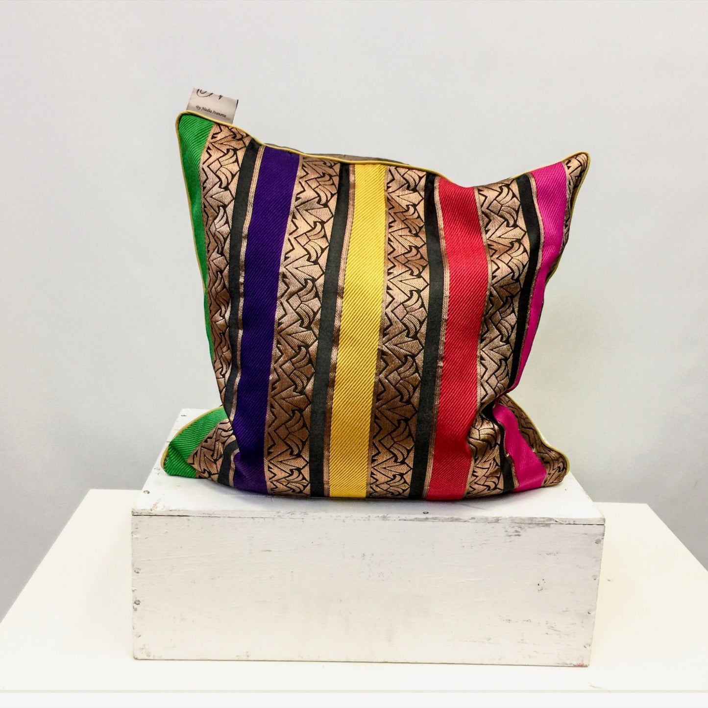 Luxurious silk cushion cover with intricate exotic patterns, adding elegance and warmth to any space. Handcrafted with fine detailing for a sophisticated home decor touch