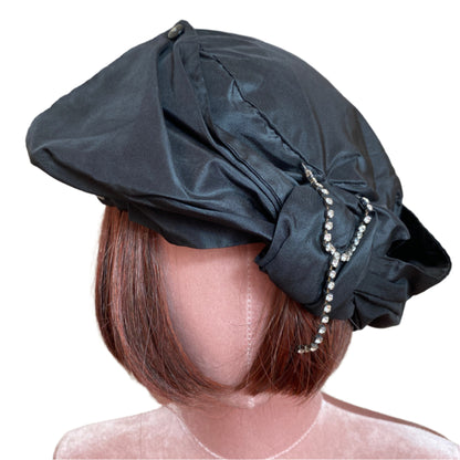 Elegant silk taffeta turban with a luxurious sheen, designed for a sophisticated and stylish look. Perfect for special occasions or adding a chic touch to everyday outfits.