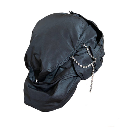 Elegant silk taffeta turban with a luxurious sheen, designed for a sophisticated and stylish look. Perfect for special occasions or adding a chic touch to everyday outfits.